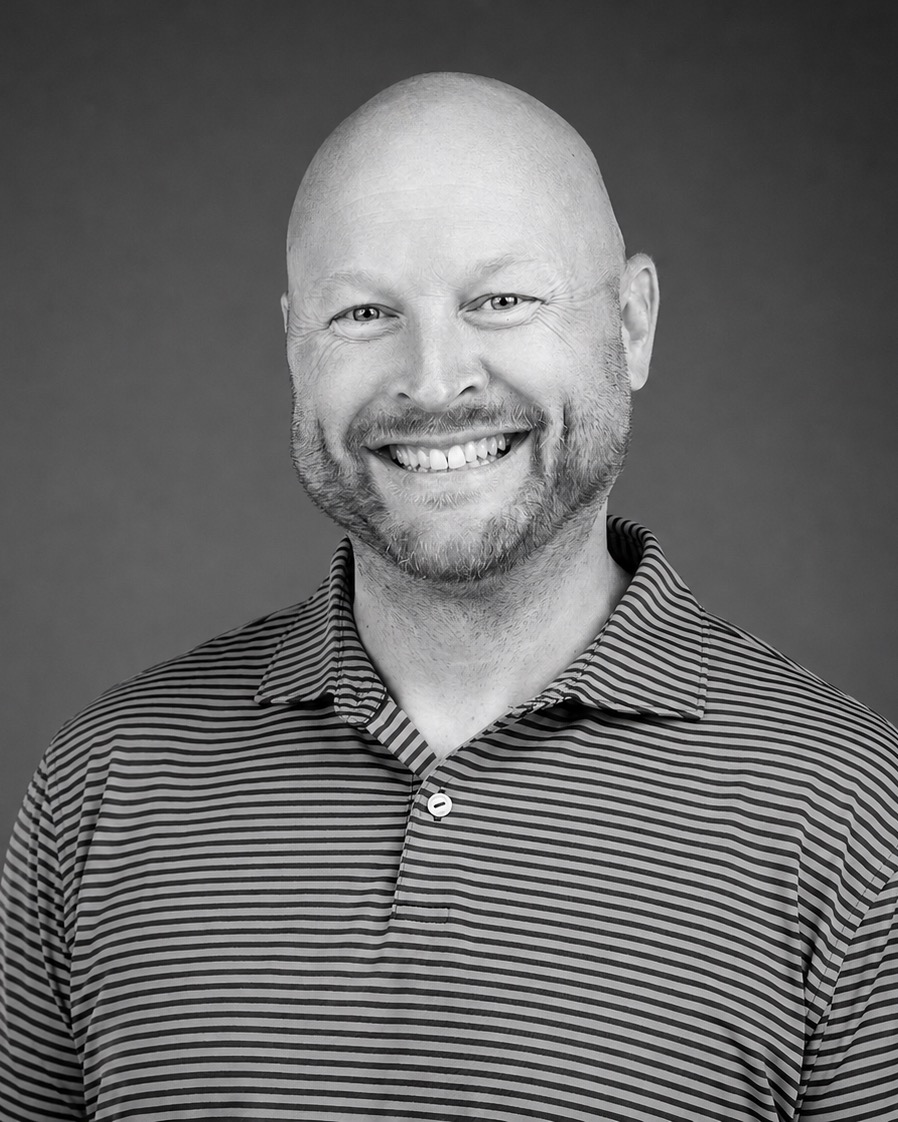 Black-and-white headshot of Derek Smelser smiling